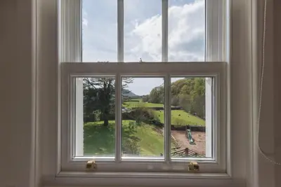 a window with a view of a golf course at 2 Bed in Eskdale SZ346 in Santon Bridge