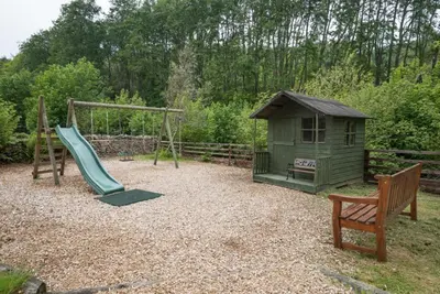 a playground with a slide and a play house at 2 Bed in Eskdale SZ346 in Santon Bridge