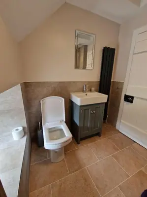 a bathroom with a toilet and a sink at The Coach House - Bargany in Girvan