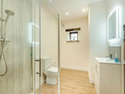a bathroom with a shower and a toilet and a sink at Herdwick House - Uk42805 in Mungrisdale