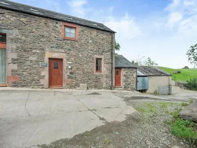 a stone house with a driveway in front of it at Herdwick House - Uk42805 in Mungrisdale