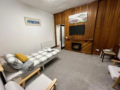 a living room with a couch and a flat screen tv at Luxury 1BR Flat Central Dumfries Self Check-in, Parking, Wi-Fi in Dumfries