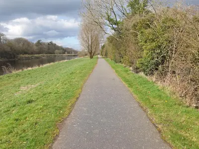 a walking path next to a river with trees at Luxury 1BR Flat Central Dumfries Self Check-in, Parking, Wi-Fi in Dumfries