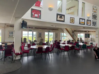 a dining room with tables and chairs in a building at Duke Travel Official TT Glamping - Douglas in Kirk Braddon