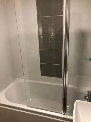 a shower with a glass door in a bathroom at Lovely Caravan in Turnberry