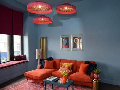 a living room with an orange couch and pink lights at The Bank - Rooms & Apartments by Coorie Doon Stays in Troon
