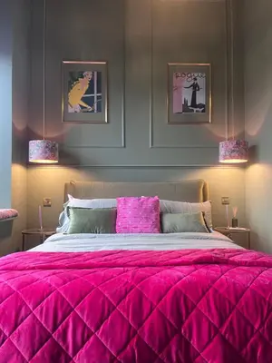 a bedroom with a large bed with a pink comforter at The Bank - Rooms & Apartments by Coorie Doon Stays in Troon