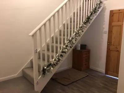 a white staircase with a christmas wreath on it at Barncroft: Dogs welcome, dog care services offered in Cockermouth