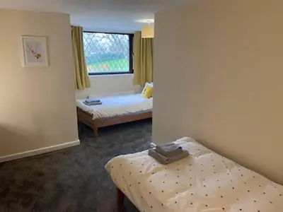 a room with two beds and a window at 17 The Park in Onchan