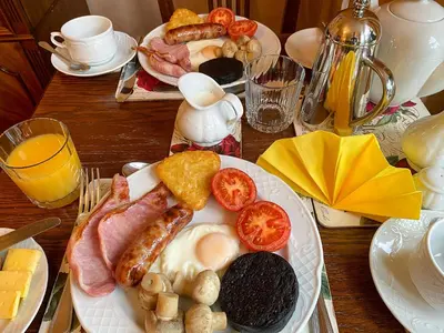 a table with a plate of breakfast food on it at Number 10 Bed & Breakfast in Keswick