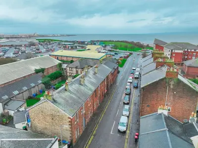 an aerial view of a city with cars parked at Barassie, Troon in Troon