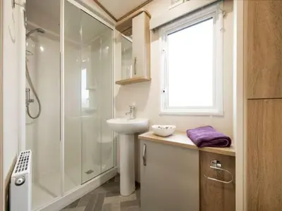 a white bathroom with a shower and a sink at Beautiful Cosy Holiday Home in Gorgeous Location - Pass the Keys in Beattock