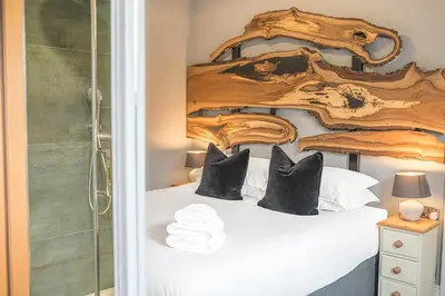 a bedroom with a bed with a wooden headboard at The Eyrie in Keswick