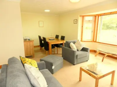 a living room with a couch and chairs and a table at Annexe Meadowbank Dumfries in Dumfries