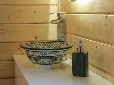 a bathroom sink with a faucet on a counter at Little Lodge in Newton Stewart