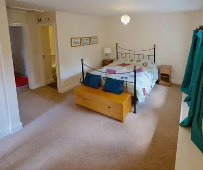 a bedroom with a bed with blue pillows on it at North Lake District rural retreat in Penrith
