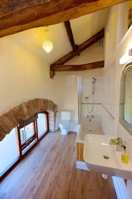 a bathroom with a sink and a bath tub at North Lake District rural retreat in Penrith