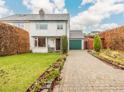 a white house with a brick driveway at 3 Bed in Portinscale 93949 in Portinscale
