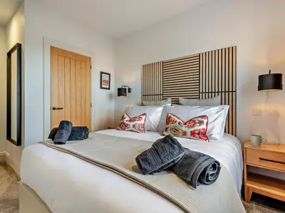a bedroom with a large white bed with pillows at 3 Bed in Loweswater 94152 in Arlecdon