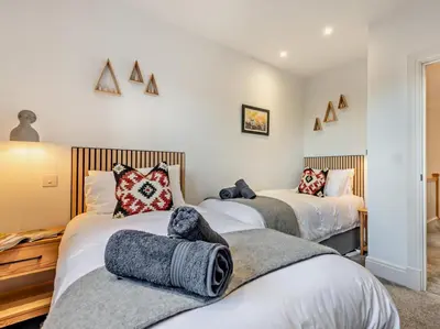 two beds in a room with white walls at 3 Bed in Loweswater 94152 in Arlecdon