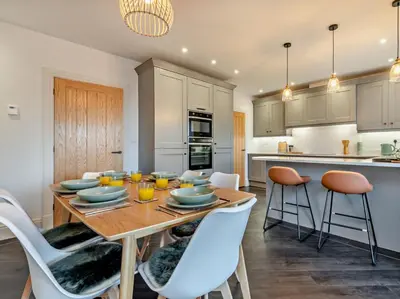 a kitchen and dining room with a table and chairs at 3 Bed in Loweswater 94152 in Arlecdon