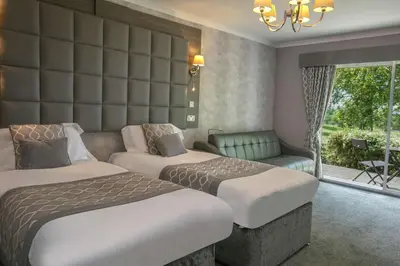 a hotel room with two beds and a couch at Dryfesdale Hotel - BW Signature Collection in Lockerbie