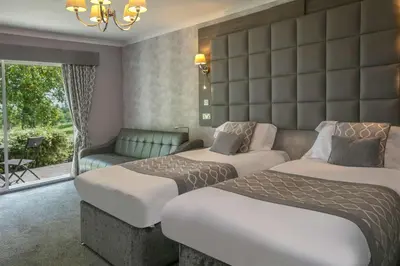 a hotel room with two beds and a couch at Dryfesdale Hotel - BW Signature Collection in Lockerbie