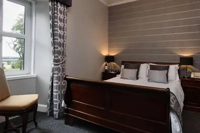 a bedroom with a bed and a window at Dryfesdale Hotel - BW Signature Collection in Lockerbie