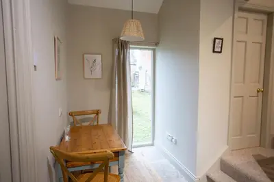 a dining room with a wooden table and a window at The Tower in Carlisle