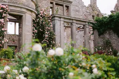 an old building with flowers in front of it at The Tower in Carlisle
