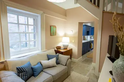 a living room with a couch and a window at The Tower in Carlisle