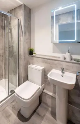 a bathroom with a toilet and a sink and a shower at *Penthouse Luxury Apartment 2min to City in Carlisle