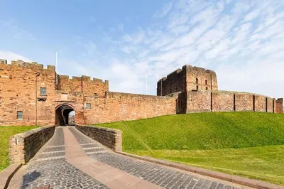 a castle on a hill with a pathway in front of it at *Penthouse Luxury Apartment 2min to City in Carlisle