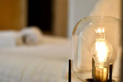 a lit light bulb in a glass jar on a table at *Penthouse Luxury Apartment 2min to City in Carlisle