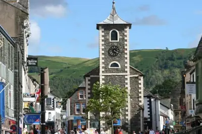 a building with a clock tower in the middle of a street at *Luxury Apartment 2min from City in Carlisle