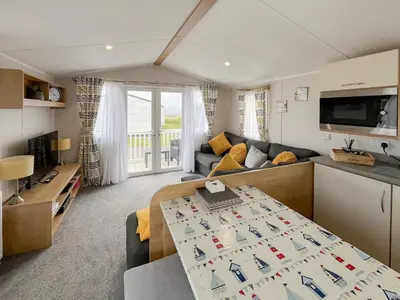 a living room with a couch and a table at Sandy Paws - Uk45511 in Mainsriddle