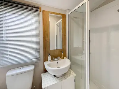 a bathroom with a toilet and a sink and a shower at Sandy Paws - Uk45511 in Mainsriddle