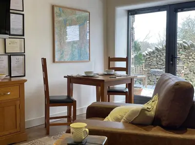 a living room with a couch and a table at 1 Bed in Watermillock 94065 in Watermillock