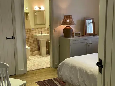 a bedroom with a bed and a bathroom with a sink at 1 Bed in Watermillock 94065 in Watermillock