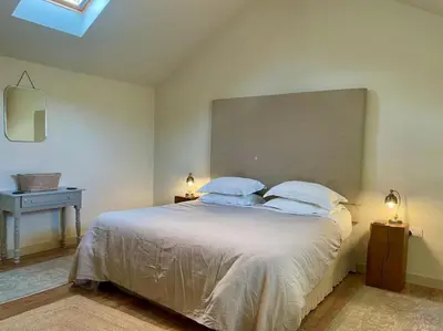 a bedroom with a large white bed with two pillows at 1 Bed in Watermillock 94068 in Watermillock
