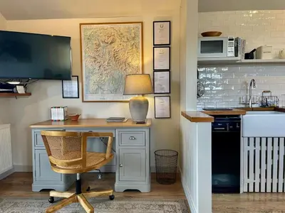 a desk with a lamp and a computer in a kitchen at 1 Bed in Watermillock 94068 in Watermillock