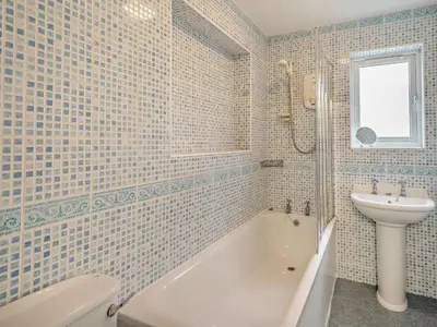 a bathroom with a sink and a tub and a toilet at 1 Bed in Keswick oc-94245 in Keswick