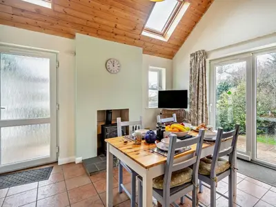 a dining room with a table and chairs and windows at 1 Bed in Keswick oc-94245 in Keswick