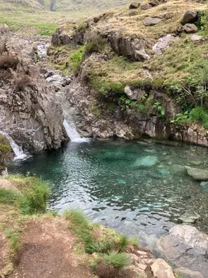 a pool of water in a river with a waterfall at Burnthwaite Farm B&B in Wasdale
