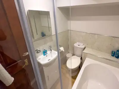 a bathroom with a white toilet and a sink at Bassenthwaite Farm Cottage, on a working farm in a tranquil setting in Bassenthwaite