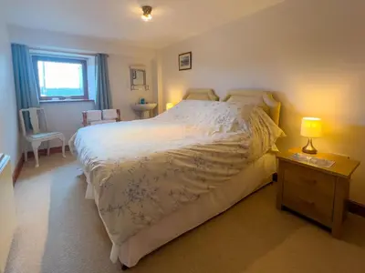 a bedroom with a bed and a table with two lamps at Fell View Bassenthwaite, rural location on a working farm in the fells in Bassenthwaite