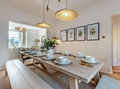 a dining room with a wooden table with dishes on it at 6 Bed in Keswick 94361 in Keswick