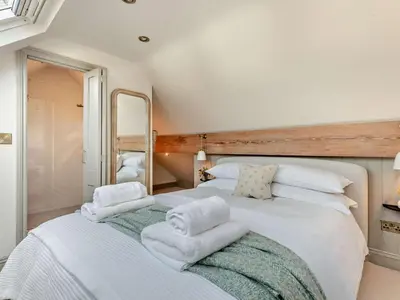a bedroom with a large white bed with towels on it at 6 Bed in Keswick 94361 in Keswick