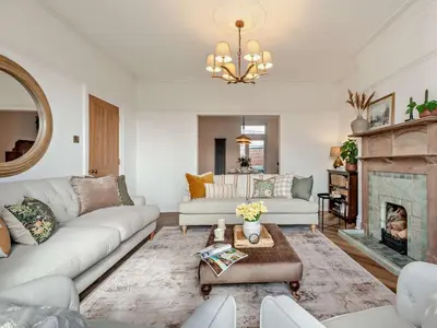 a living room with white furniture and a fireplace at 6 Bed in Keswick 94361 in Keswick