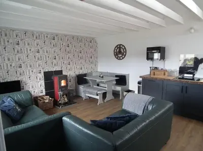 a living room with a couch and a table at Borrowmoss Bothy, Charming & Characterful property, Wigtown in Wigtown